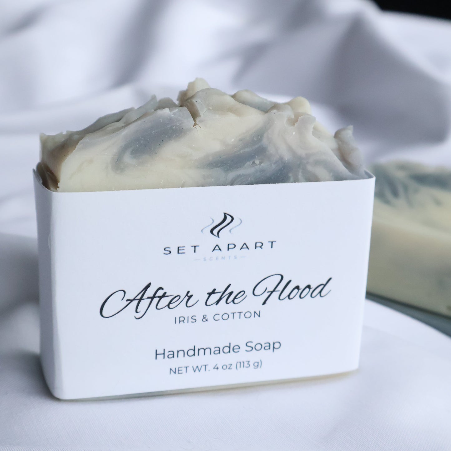 Bar of soap with a white label on a blurred background